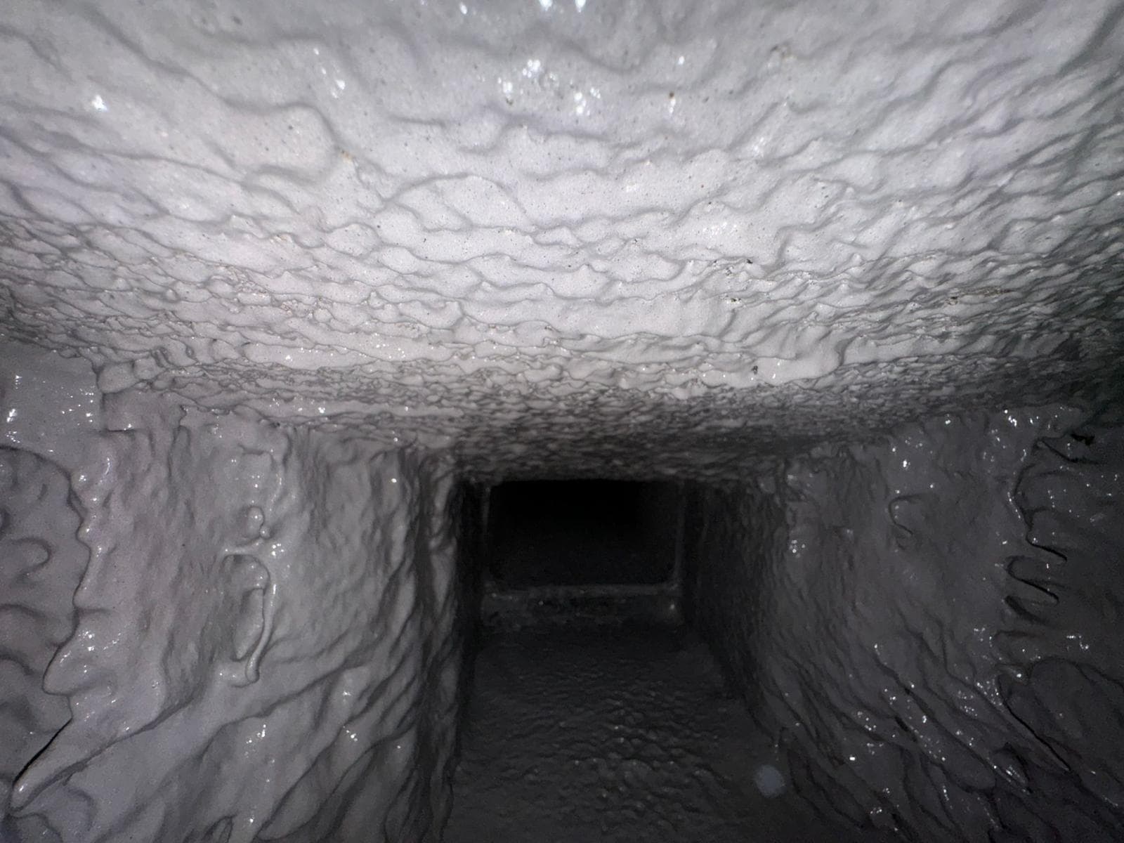 The same smoke chamber after parging, showing a smooth sealed surface that improves draft and reduces creosote buildup